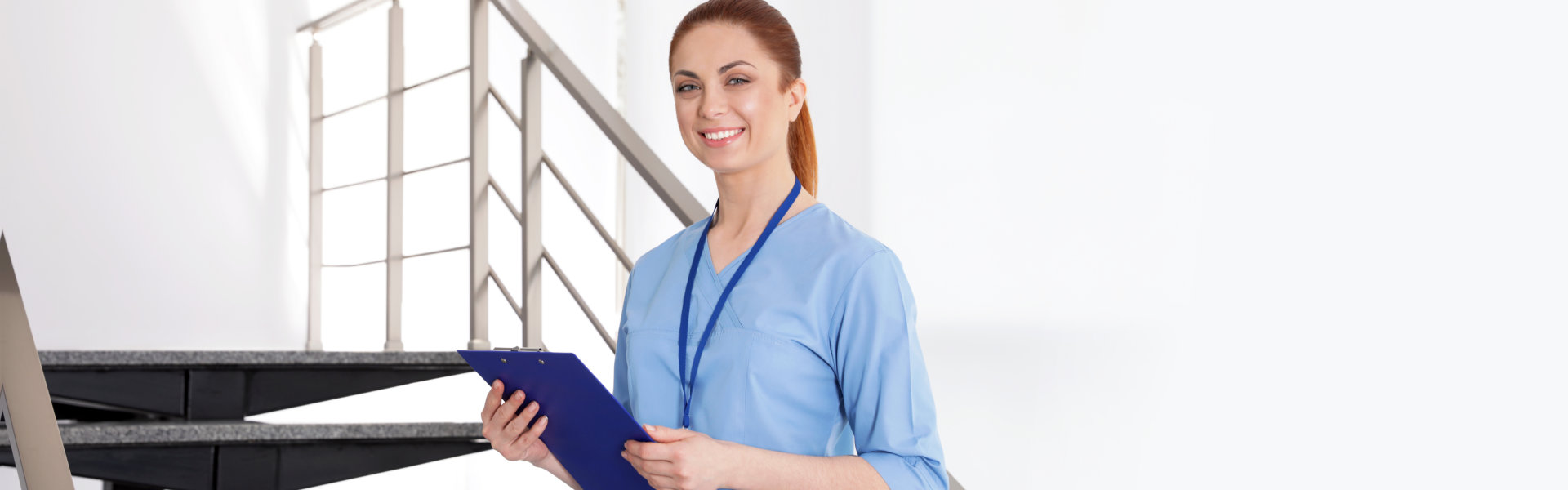 nurse holding folder and looking at the camera