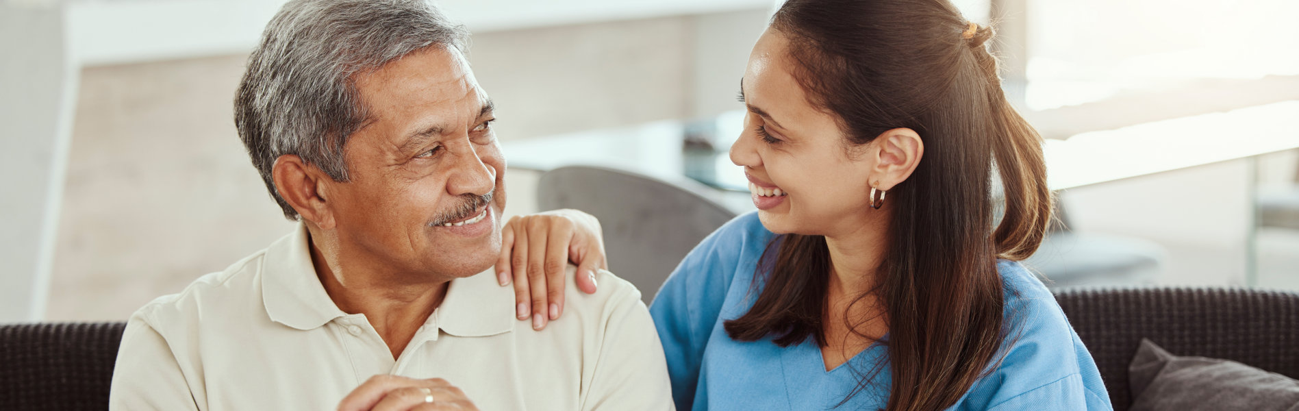 nurse and elderly man looking at each other